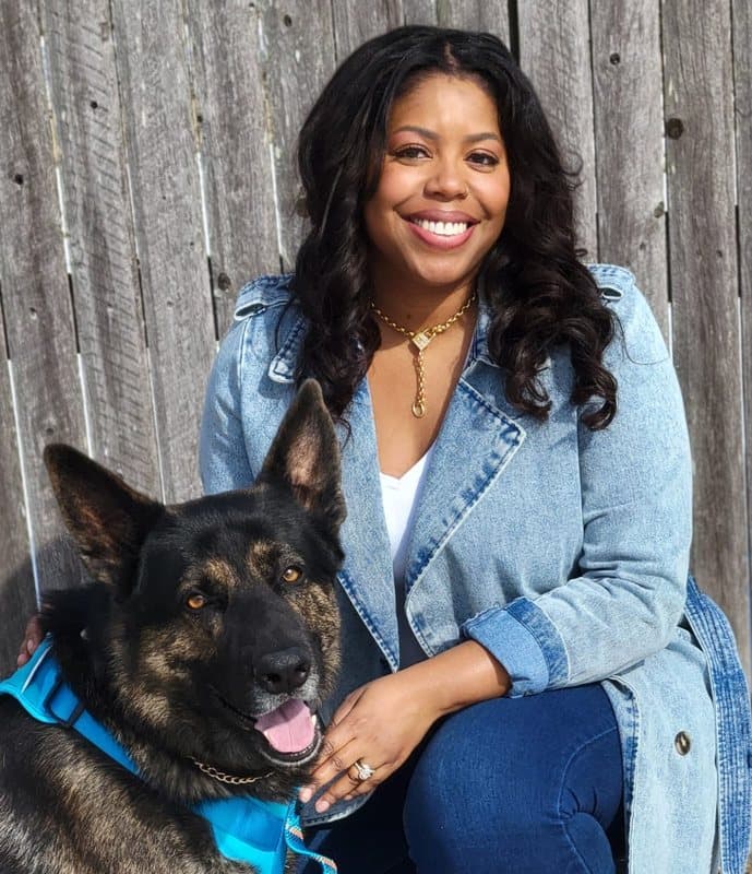 Kiana Perkins, founder and CEO of Moona's Place, with a German Shepherd.